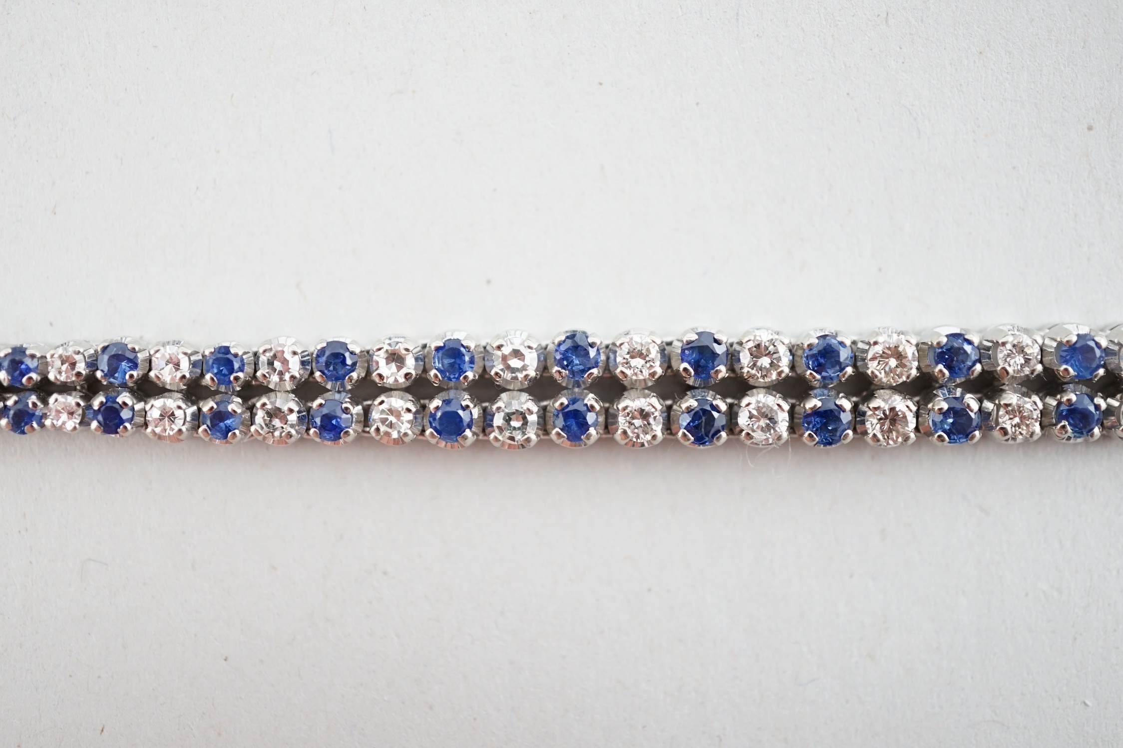 A 1960's 14ct white gold, sapphire and diamond two row line bracelet